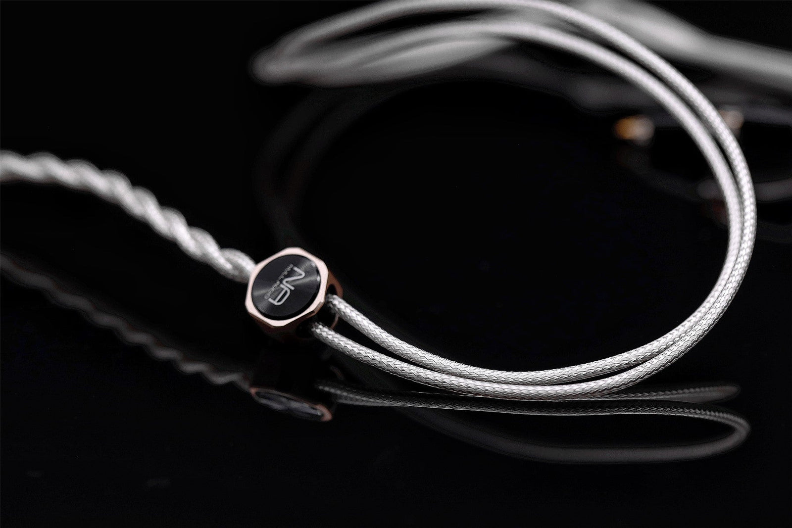 Ethos MKVI silver-plated copper IEM cable with rose-gold Y-split on a black background