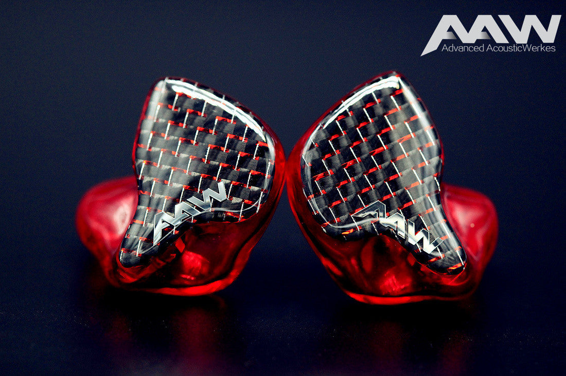 Pair of red AAW custom IEM shells with carbon fibre faceplates