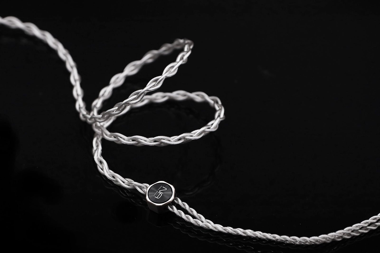 Lune MKVIII silver braided IEM cable with Null Audio Y-split on a dark background
