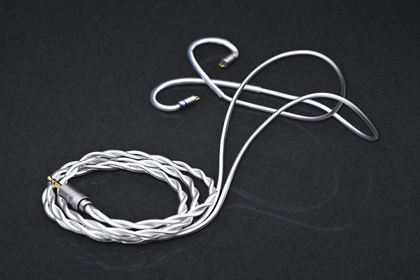 Ethos Ultra coaxial IEM cable with 3.5 mm plug, coiled on a dark studio backdrop