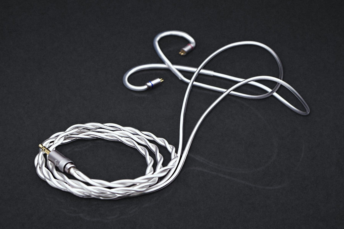 Ethos Ultra coaxial IEM cable with 3.5 mm plug, coiled on a dark studio backdrop